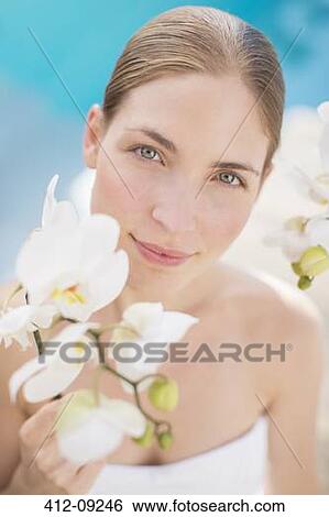 Woman holding flower poolside View Large Photo Image Stock Photograph - Woman holding flower poolside. Fotosearch