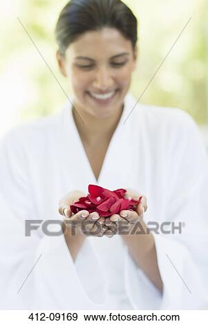 Woman holding handful of flower petals View Large Photo Image Stock Photo - Woman holding handful of flower petals. Fotosearch
