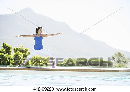 Woman practicing yoga at poolside View Large Photo Image Stock Image - Woman practicing yoga at poolside. Fotosearch
