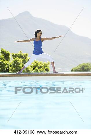 Woman practicing yoga at poolside View Large Photo Image Stock Photo - Woman practicing yoga at poolside. Fotosearch