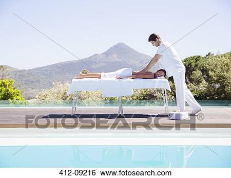 Woman receiving massage at poolside View Large Photo Image Stock Photograph - Woman receiving massage at poolside. Fotosearch