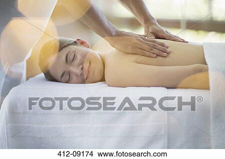 Picture - Woman receiving massage at spa. Fotosearch