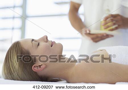 Stock Photo - Woman receiving massage at spa. Fotosearch