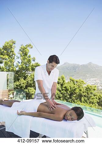Woman receiving massage on spa patio View Large Photo Image Stock Photo - Woman receiving massage on spa patio. Fotosearch