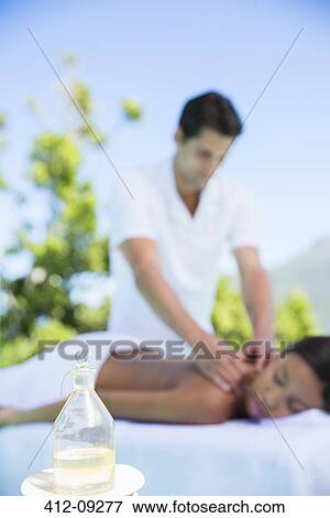 Woman receiving massage on spa patio View Large Photo Image Stock Photo - Woman receiving massage on spa patio. Fotosearch