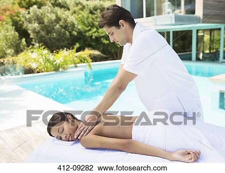 Woman receiving massage poolside at spa View Large Photo Image Stock Image - Woman receiving massage poolside at spa. Fotosearch