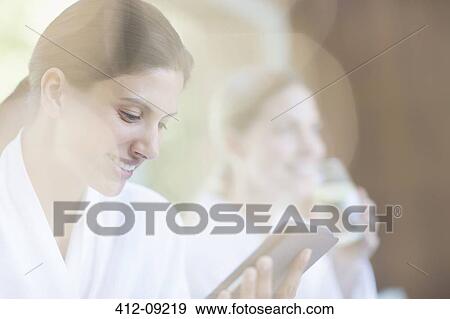 Stock Photo - Woman using digital tablet at spa. Fotosearch