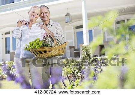Portrait of senior couple hugging in garden View Large Photo Image Picture - Portrait of senior couple hugging in garden. Fotosearch