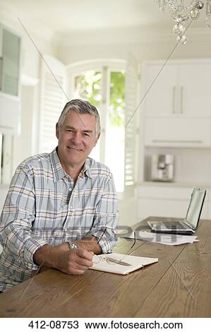 Portrait of senior man at kitchen table View Large Photo Image Stock Image - Portrait of senior man at kitchen table. Fotosearch
