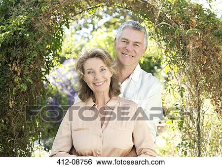 Portrait of smiling senior couple in garden View Large Photo Image Stock Photograph - Portrait of smiling senior couple in garden. Fotosearch