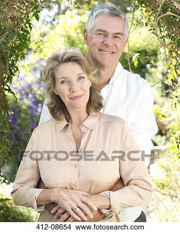 Portrait of smiling senior couple hugging outdoors View Large Photo Image Picture - Portrait of smiling senior couple hugging outdoors. Fotosearch