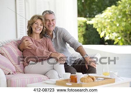 Portrait of smiling senior couple enjoying breakfast on patio View Large Photo Image Stock Image - Portrait of smiling senior couple enjoying breakfast on patio. Fotosearch