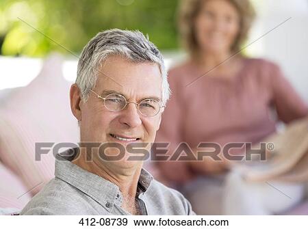 Stock Photo - Portrait of smiling senior man on patio. Fotosearch