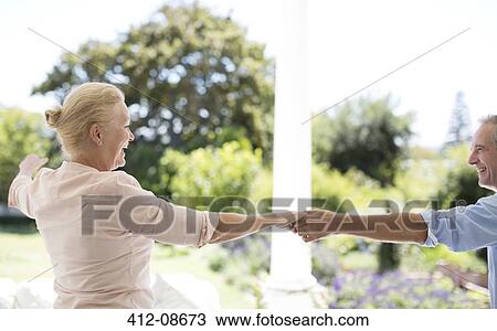 Senior couple dancing on patio View Large Photo Image Stock Image - Senior couple dancing on patio. Fotosearch
