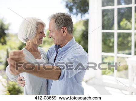 Stock Photo - Senior couple dancing on patio. Fotosearch