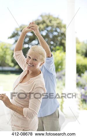 Stock Photo - Senior couple dancing on patio. Fotosearch