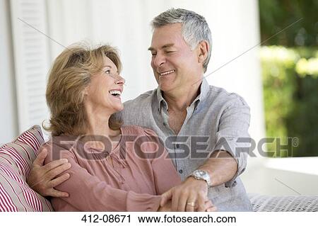 Senior couple hugging in armchair on patio View Large Photo Image Stock Image - Senior couple hugging in armchair on patio. Fotosearch