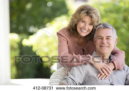 Senior couple hugging on patio View Large Photo Image Stock Image - Senior couple hugging on patio. Fotosearch