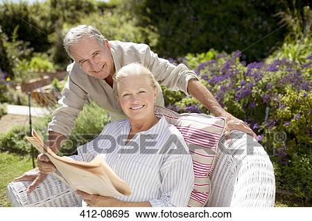 Senior couple reading newspaper in garden View Large Photo Image Stock Photography - Senior couple reading newspaper in garden. Fotosearch