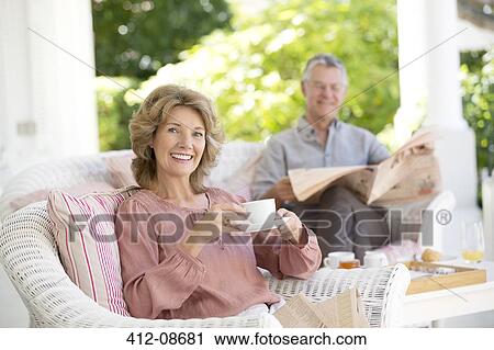 Stock Image - Senior couple relaxing on patio. Fotosearch