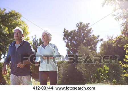 Senior couple running in park View Large Photo Image Picture - Senior couple running in park. Fotosearch