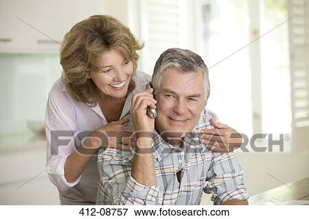 Senior couple talking on telephone View Large Photo Image Stock Photo - Senior couple talking on telephone. Fotosearch