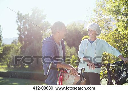 Senior couple with bicycles in park View Large Photo Image Stock Image - Senior couple with bicycles in park. Fotosearch