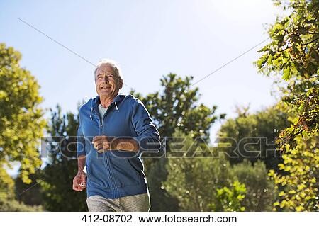 Senior man running in park View Large Photo Image Stock Image - Senior man running in park. Fotosearch