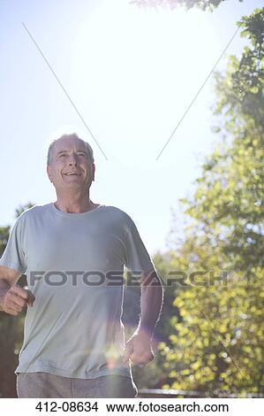 Picture - Senior man running outdoors. Fotosearch