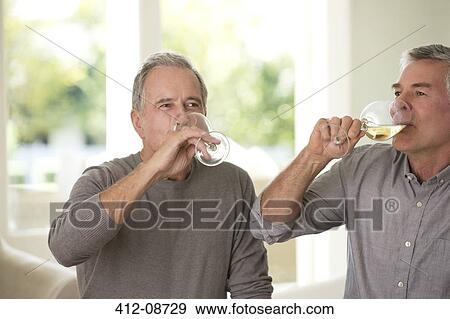 Stock Photo - Senior men drinking wine. Fotosearch
