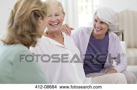 Senior women talking on sofa View Large Photo Image Picture - Senior women talking on sofa. Fotosearch