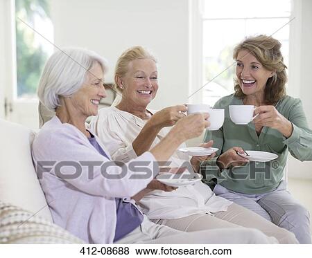 Senior women toasting coffee cups View Large Photo Image Stock Photo - Senior women toasting coffee cups. Fotosearch