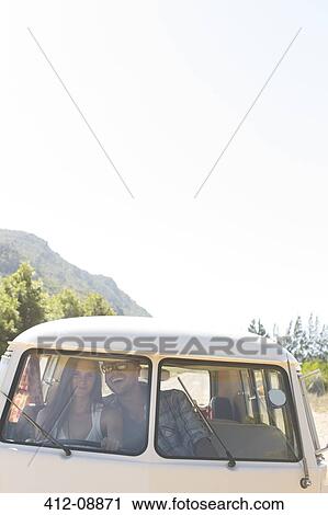 Couple driving camper van on rural road View Large Photo Image Stock Image - Couple driving camper van on rural road. Fotosearch