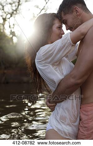 Couple hugging by river View Large Photo Image Stock Image - Couple hugging by river. Fotosearch