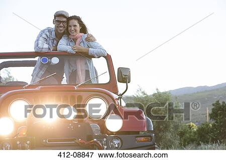 Couple hugging in sport utility vehicle View Large Photo Image Stock Photo - Couple hugging in sport utility vehicle. Fotosearch