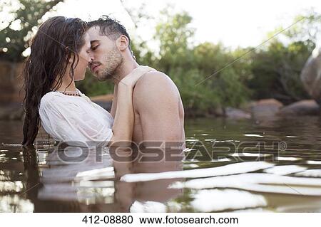Couple kissing in river View Large Photo Image Stock Image - Couple kissing in river. Fotosearch