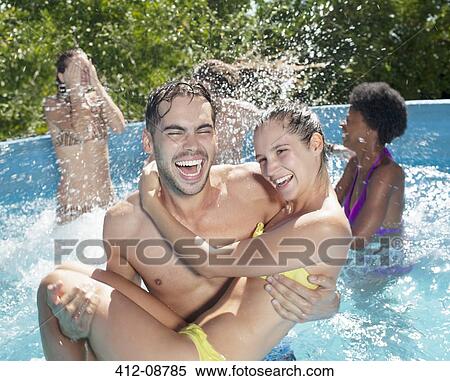 Stock Photography - Couple playing in swimming pool. Fotosearch