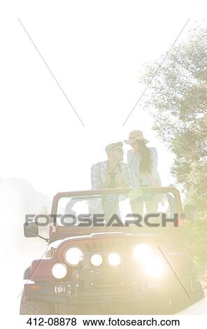 Couple standing in sport utility vehicle View Large Photo Image Stock Photo - Couple standing in sport utility vehicle. Fotosearch
