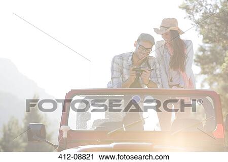 Couple with digital camera in sport utility vehicle View Large Photo Image Stock Image - Couple with digital camera in sport utility vehicle. Fotosearch