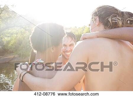 Stock Photograph - Friends at riverside. Fotosearch