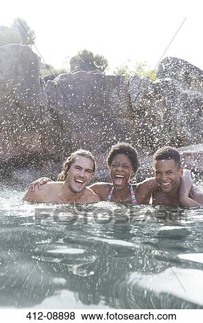 Stock Photo - Friends laughing in river. Fotosearch
