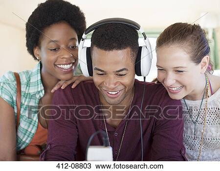 Friends listening to mp3 player in car View Large Photo Image Stock Image - Friends listening to mp3 player in car. Fotosearch