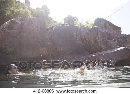 Stock Photograph - Friends playing in river. Fotosearch