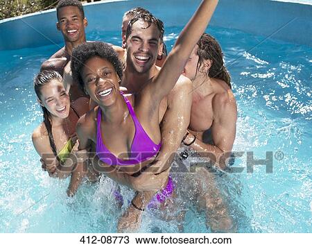 Friends playing in swimming pool View Large Photo Image Stock Image - Friends playing in swimming pool. Fotosearch