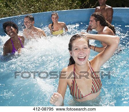Friends playing in swimming pool View Large Photo Image Stock Photography - Friends playing in swimming pool. Fotosearch