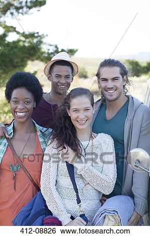 Friends smiling outdoors View Large Photo Image Stock Photograph - Friends smiling outdoors. Fotosearch