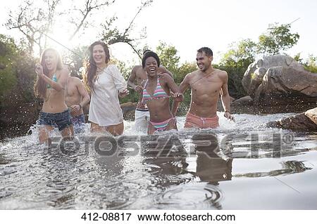 Friends wading in river View Large Photo Image Stock Photo - Friends wading in river. Fotosearch