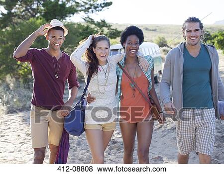 Friends walking on beach View Large Photo Image Stock Photo - Friends walking on beach. Fotosearch