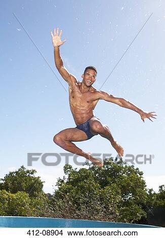 Picture - Man in swim trunks jumping. Fotosearch