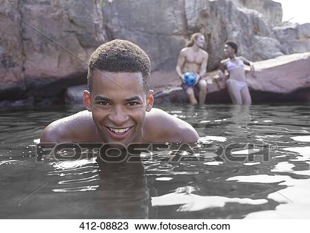 Stock Image - Man swimming in river. Fotosearch